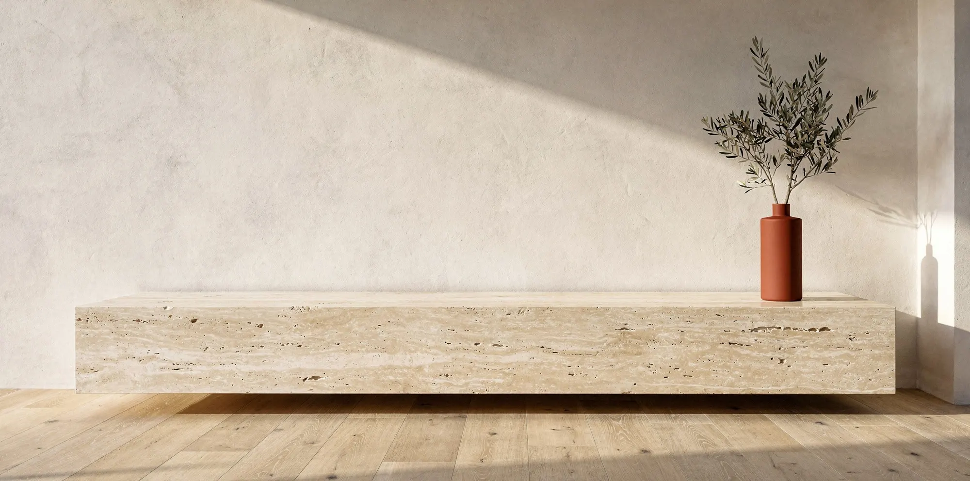 Travertine console with an olive branch in a terracotta vase